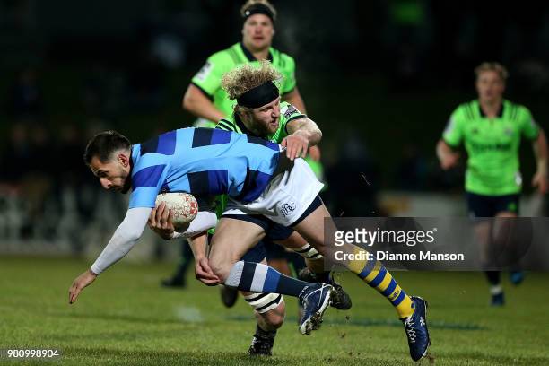 Julien Dumora of the French Barbarians is tackled by Josh Dixon of the Highlanders during the match between the Highlanders and the French Barbarians...