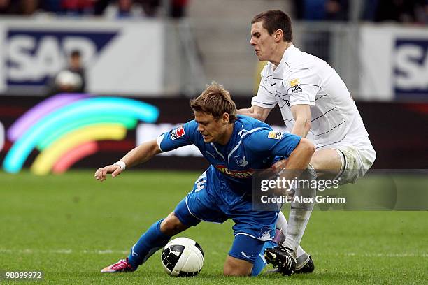 Boris Vukcevic of Hoffenheim is challenged by Johannes Flum of Freiburg during the Bundesliga match between 1899 Hoffenheim and SC Freiburg at the...