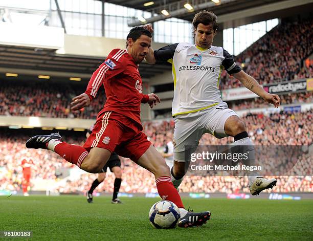 Lorik Cana of Sunderland challenges Maxi Rodriguez of Liverpool during the Barclays Premier League match between Liverpool and Sunderland at Anfield...