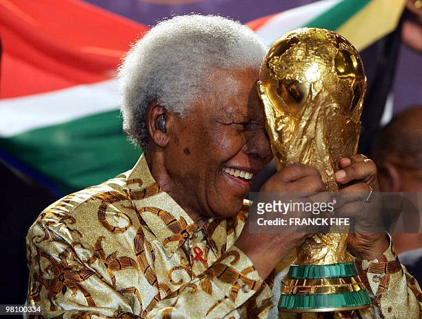South African former President Nelson Mandela holds the Jules Rimet World cup, 15 May 2004 at the FIFA headquarters in Zurich. South Africa won the...
