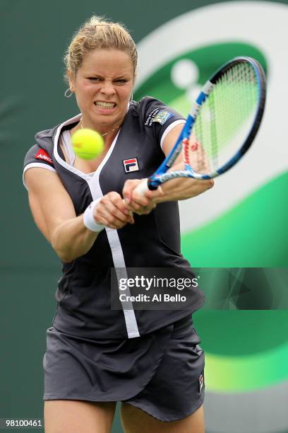 Kim Clijsters of Belgium returns a shot against Shahar Peer of Israel during day six of the 2010 Sony Ericsson Open at Crandon Park Tennis Center on...