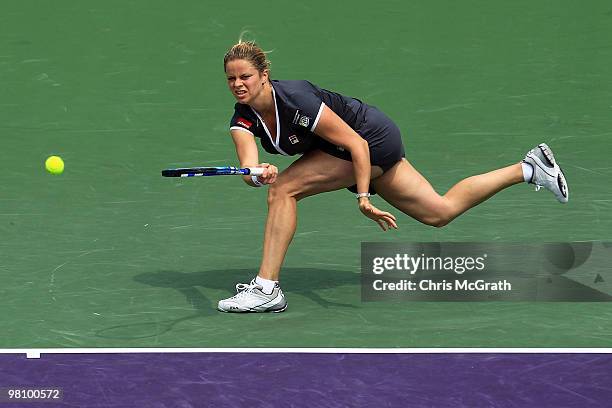 Kim Clijsters of Belgium returns a shot against Shahar Peer of Israel during day six of the 2010 Sony Ericsson Open at Crandon Park Tennis Center on...