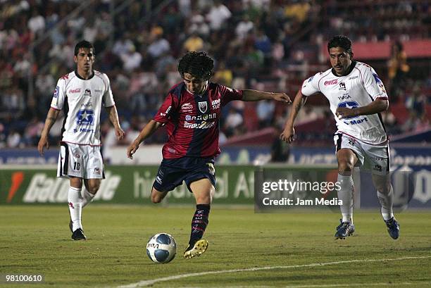 Atlante's player Christian Bermudes vies for the ball with Adrian Garcia of Indios during their match as part of 2010 Bicentenario Tournament at...