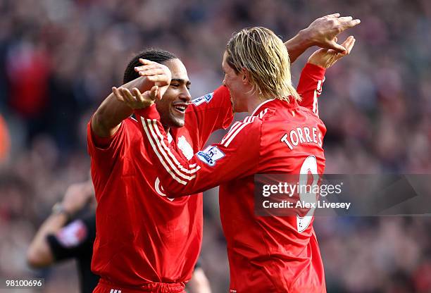 Fernando Torres of Liverpool celebrates scoring his team's third goal with team mate Glen Johnson during the Barclays Premier League match between...