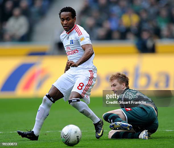 Ze Roberto of Hamburg is challenged by Marco Reus of Gladbach during the Bundesliga match between Borussia Moenchengladbach and Hamburger SV at...