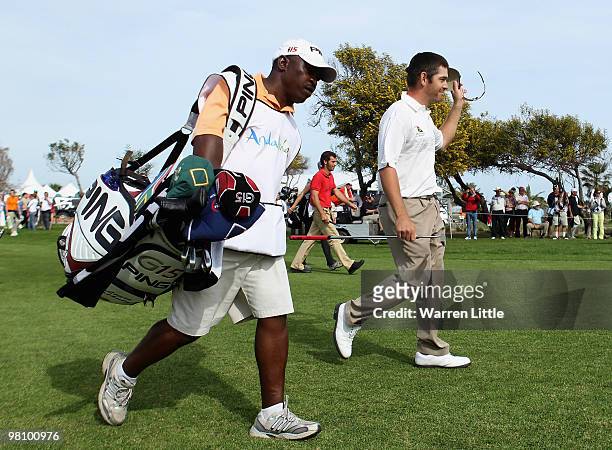 Louis Oosthuizen of South Africa walks up the 18th fairway with his caddie Zack en-route to winning the Open de Andalucia 2010 at Parador de Malaga...