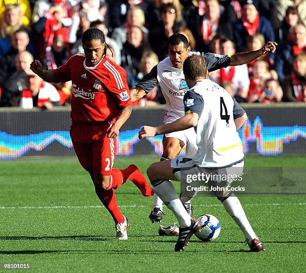 Glen Johnson of Liverpool gets his boot kicked off by Paulo de Silva of Sunderland during the Barclays Premier League match between Liverpool and...