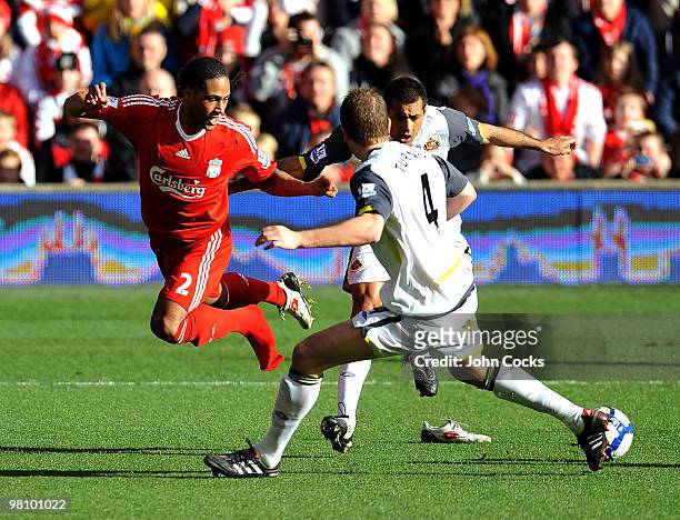 Glen Johnson of Liverpool gets his boot kicked off by Paulo de Silva of Sunderland during the Barclays Premier League match between Liverpool and...