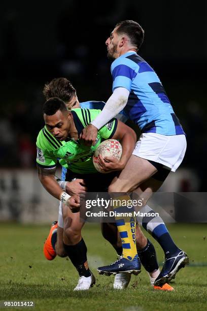 Tevita Li of the Highlanders is tackled by Hugo Bonneval and Julien Dumora of the French Barbarians during the match between the Highlanders and the...
