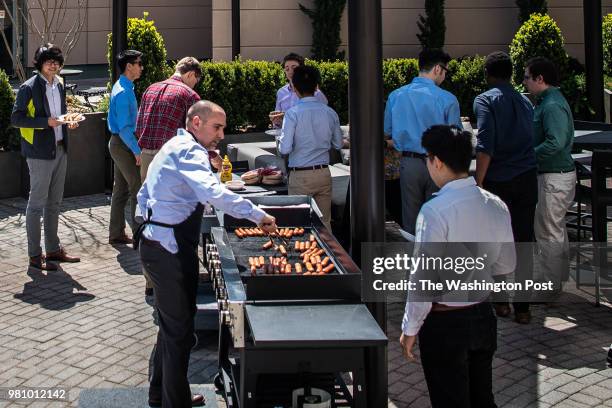 Employees are seen during a BBQ at Macedon Technologies on Tuesday, May 1 in Reston, VA.