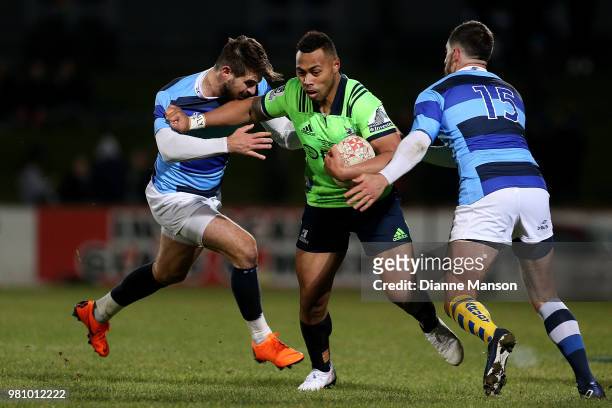 Tevita Li of the Highlanders fends off Hugo Bonneval during the match between the Highlanders and the French Barbarians at Rugby Park Stadium on June...