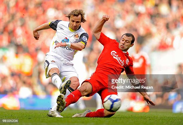 Bolo Zenden of Sunderland is tackled by Javier Mascherano of Liverpool during the Barclays Premier League match between Liverpool and Sunderland at...