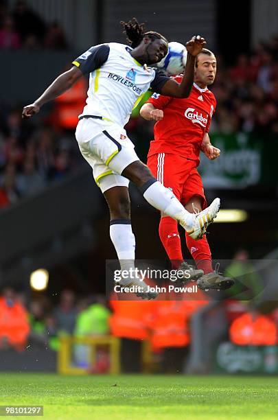 Javier Mascherano of Liverpool goes up with Kenwyne Jones of Sunderland saves it during the Barclays Premier League match between Liverpool and...