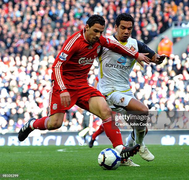 Maxi Rodriguez of Liverpool competes with Kieran Richardson of Sunderland during the Barclays Premier League match between Liverpool and Sunderland...