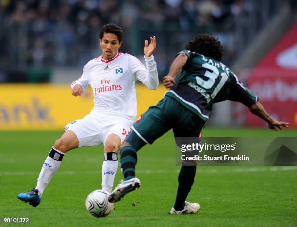 Paolo Guerrero of Hamburg is challenged by Dante of Gladbach during the Bundesliga match between Borussia Moenchengladbach and Hamburger SV at...