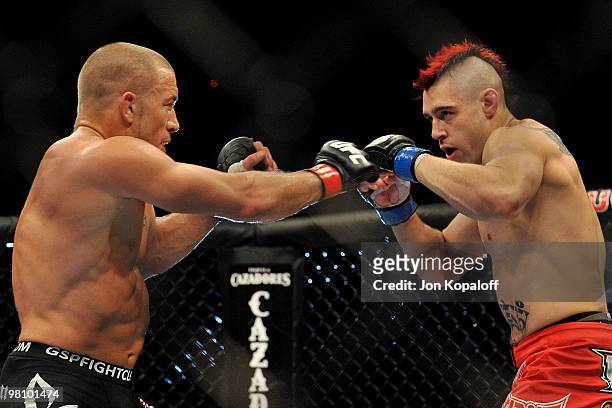 Fighter Georges St-Pierre touches gloves with Dan Hardy during their Welterweight title bout at UFC 111 at the Prudential Center on March 27, 2010 in...