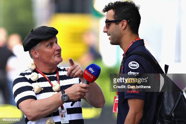 Daniel Ricciardo of Australia and Red Bull Racing talks with Johnny Herbert of Sky Sports in the Paddock before practice for the Formula One Grand...