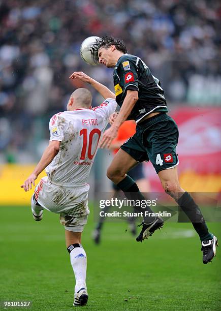 Mladen Petric of Hamburg is challenged by Roel Brouwers of Gladbach during the Bundesliga match between Borussia Moenchengladbach and Hamburger SV at...