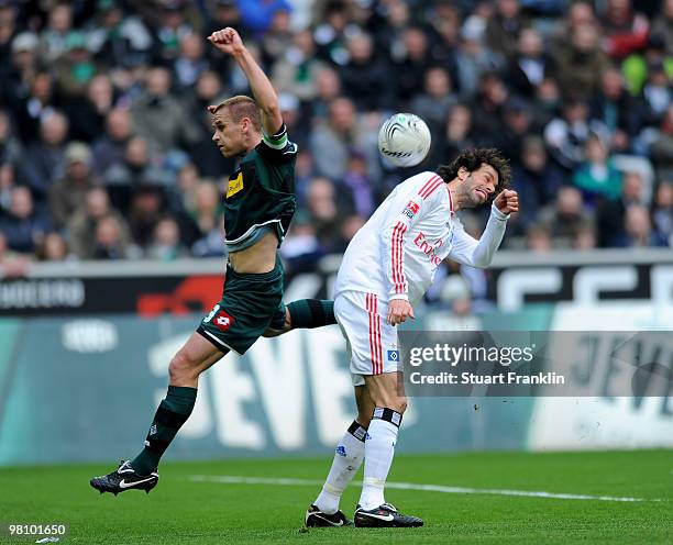 Ruud Van Nistelrooy of Hamburg is challenged by Filip Daems of Gladbach during the Bundesliga match between Borussia Moenchengladbach and Hamburger...