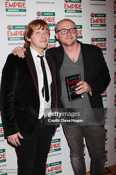 Rupert Grint poses with Simon Pegg after presenting him with the best sci-fi award for Star Trek in front of the winners boards at the Jameson Empire...