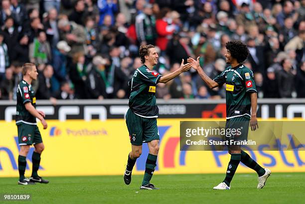 Roel Brouwers of Gladbach celebrates scoring his team's first goal with Dante during the Bundesliga match between Borussia Moenchengladbach and...
