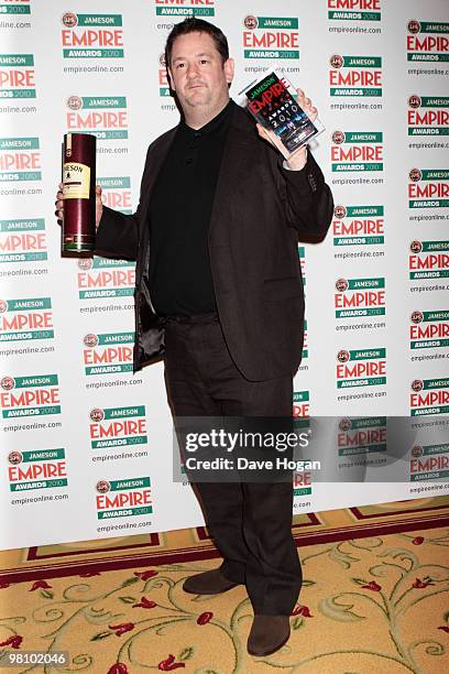 Johnny Vegas poses after picking up Zoe Saldanas Best Actress Award in front of the winners boards at the Jameson Empire Film Awards 2010 held at the...