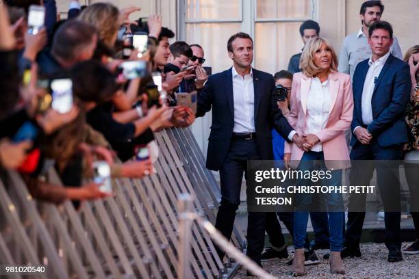 French President Emmanuel Macron and his wife Brigitte Macron attend the 'Fete de la Musique', the music day celebration in the courtyard of the...