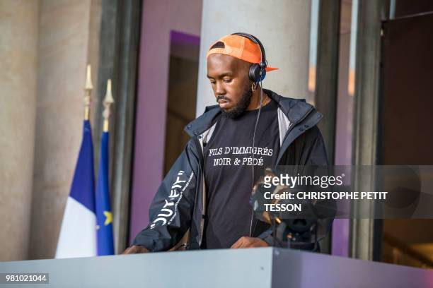 French DJ Kiddy Smile wears a tee-shirt reading "Immigrant's son, black and gay" as he performs during the 'Fete de la Musique', the music day...