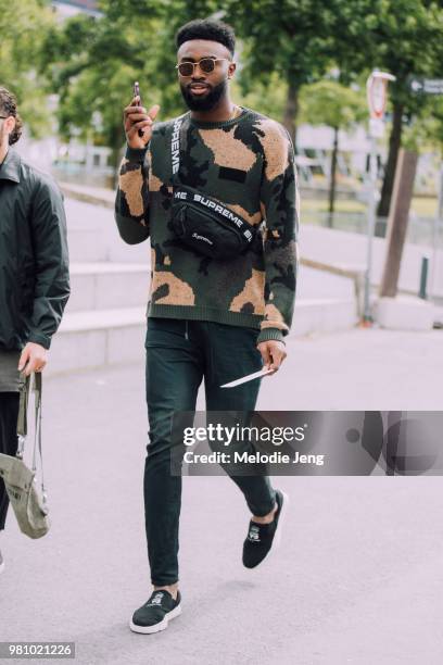 Basketball player Jaylen Brown in a camo top and Supreme fanny pack during Paris Fashion Week Mens Spring/Summer 2019 on June 21, 2018 in Paris,...