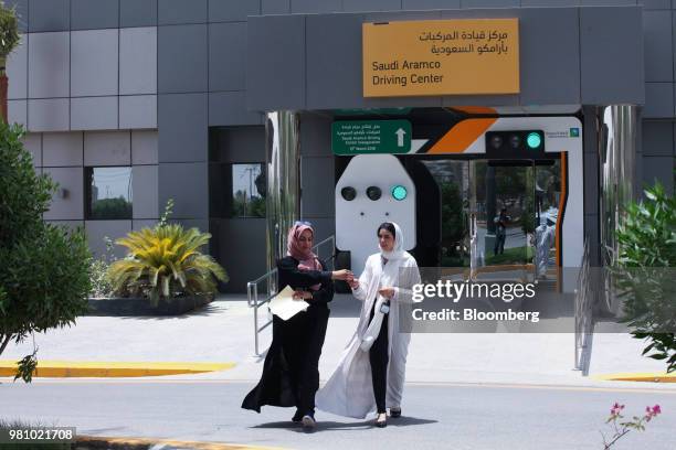 An instructor hands a trainee the keys to an automobile before learning to drive a real car at the Saudi Aramco driving school for women at the...