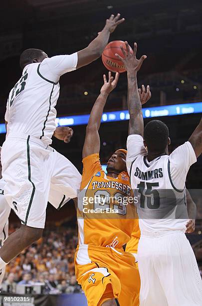 Cameron Tatum of the Tennessee Volunteers is blocked by Draymond Green and Durrell Summers of the Michigan State Spartans during the midwest regional...