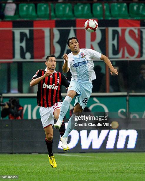 Marco Borriello of AC Milan competes for the ball with Andre Dias of SS Lazio during the Serie A match between AC Milan and SS Lazio at Stadio...