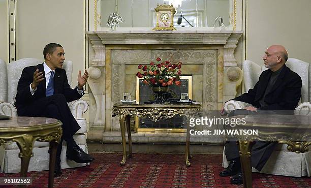 President Barack Obama speaks with Afghan President Hamid Karzai during a meeting at the Presidential Palace in Kabul, Afghanistan, March 28, 2010....