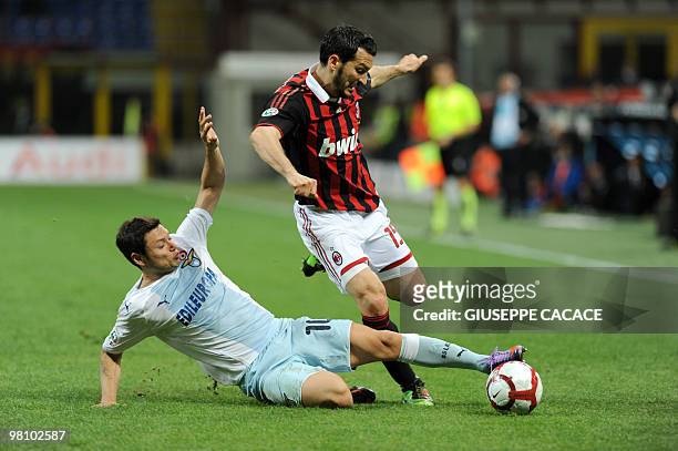 Lazio's Argentine forward Mauro Matias Zarate challenges for the ball with AC Milan's defender Gianluca Zambrotta during their Serie A football match...