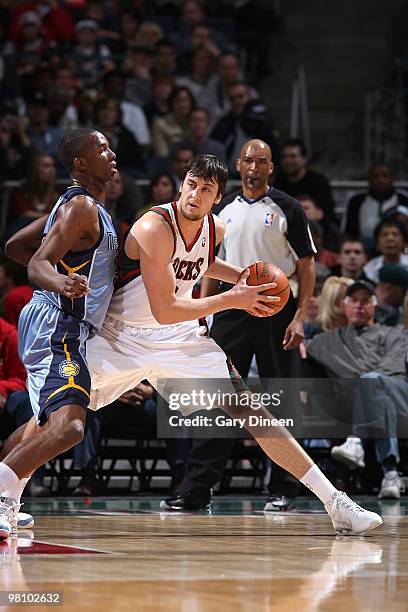 Andrew Bogut of the Milwaukee Bucks posts up against Hasheem Thabeet of the Memphis Grizzlies on March 28, 2010 at the Bradley Center in Milwaukee,...