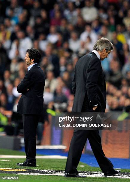 Atletico Madrid's coach Quique Sanchez Flores and Real Madri'd coach Manuel Pellegrini react during the Spanish league football match Real Madrid...