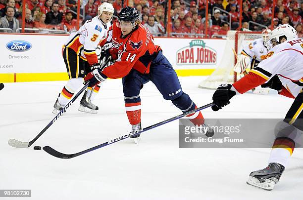 Tomas Fleischmann of the Washington Capitals reaches for the puck against the Calgary Flames on March 28, 2010 in Washington, DC.