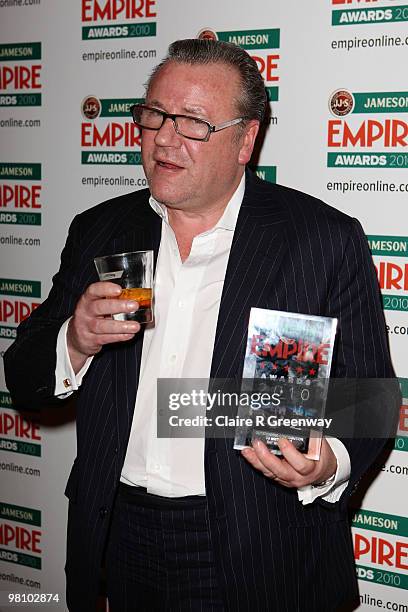 Ray Winstone poses with the Outstanding Contribution to British Film award at the Winners Boards at the Jameson Empire Film Awards held at the...