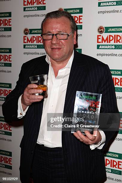 Ray Winstone poses with the Outstanding Contribution to British Film award at the Winners Boards at the Jameson Empire Film Awards held at the...