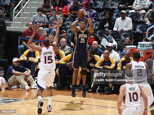 Brandon Rush of the Indiana Pacers takes a three-point shot against Al Horford of the Atlanta Hawks on March 28, 2010 at Philips Arena in Atlanta,...