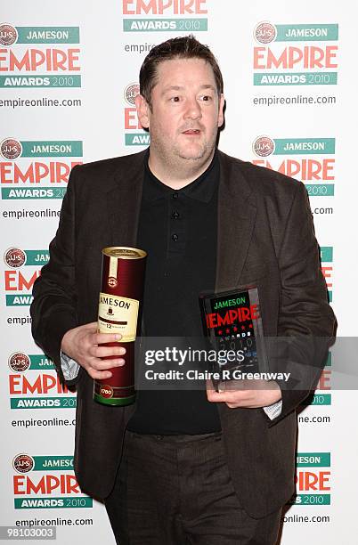 Johnny Vegas poses with the award for Best Actress collected on behalf of Zoe Saldana at the Winners Boards at the Jameson Empire Film Awards held at...