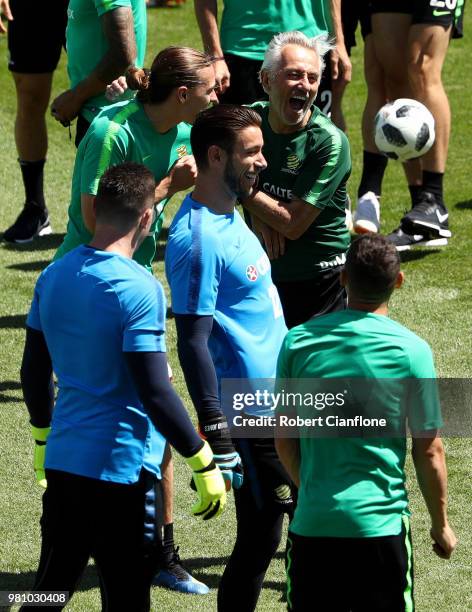 Bert van Marwijk, Head coach of Australia and Jackson Irvine of Australia laugh as players look on during an Australian Socceroos training session at...