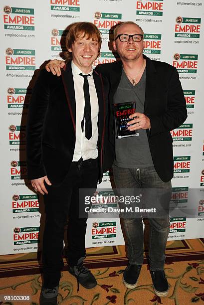 Simon Pegg poses with the Best Sci-Fi/Fantasy Award presented by Rupert Grint during the Jameson Empire Film Awards at the Grosvenor House Hotel, on...