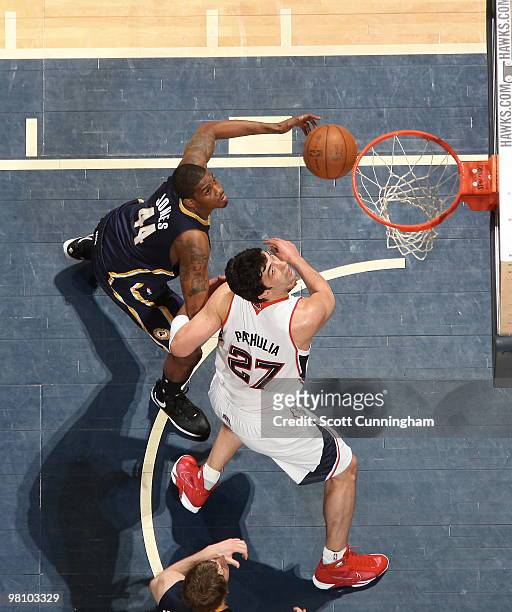 Zaza Pachulia of the Atlanta Hawks battles for rebound positioning against Solomon Jones of the Indiana Pacers on March 28, 2010 at Philips Arena in...