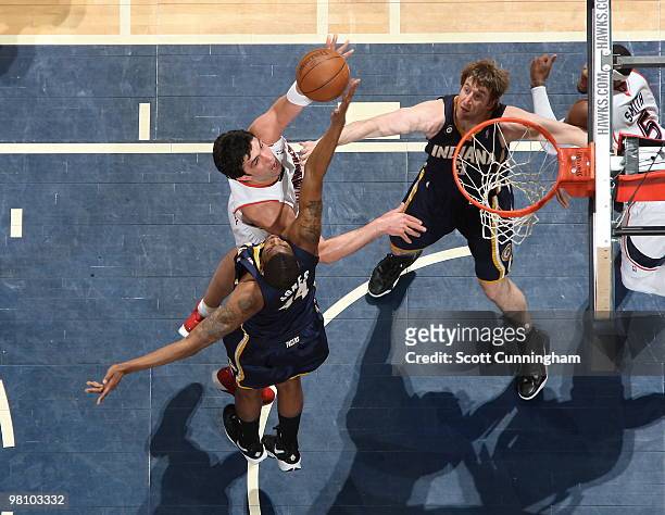 Zaza Pachulia of the Atlanta Hawks puts up a shot against Solomon Jones of the Indiana Pacers on March 28, 2010 at Philips Arena in Atlanta, Georgia....