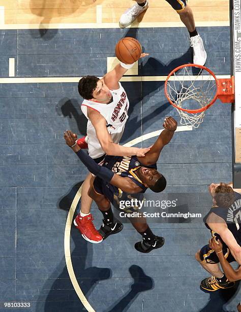 Zaza Pachulia of the Atlanta Hawks puts up a shot over Roy Hibbert of the Indiana Pacers on March 28, 2010 at Philips Arena in Atlanta, Georgia. NOTE...