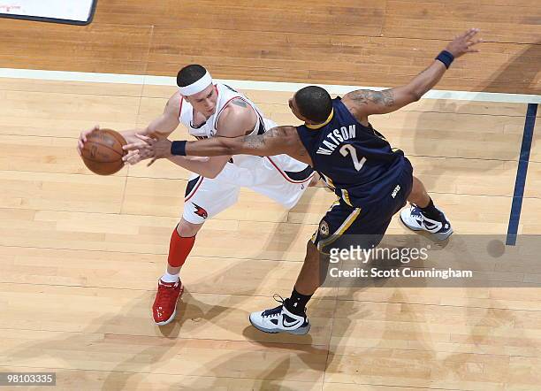 Mike Bibby of the Atlanta Hawks looks to make a pass against Earl Watson of the Indiana Pacers on March 28, 2010 at Philips Arena in Atlanta,...