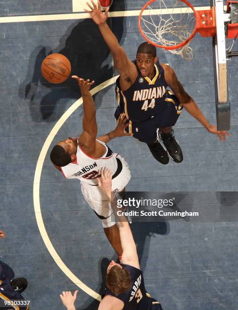Joe Johnson of the Atlanta Hawks puts up a shot against Solomon Jones of the Indiana Pacers on March 28, 2010 at Philips Arena in Atlanta, Georgia....