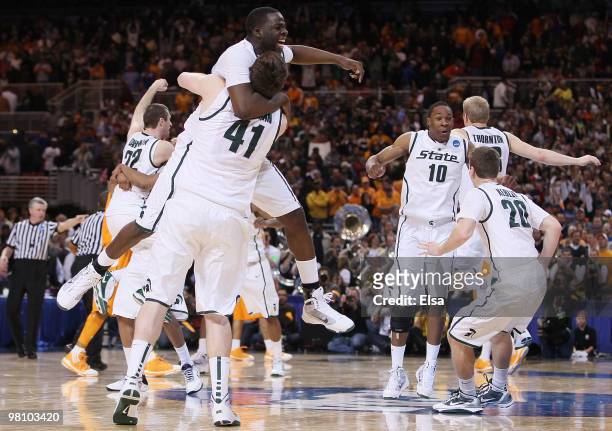 : : Draymond Green, Garrick Sherman and the res of the Michigan State Spartans celebrate the win over Tennessee during the midwest regional final of...
