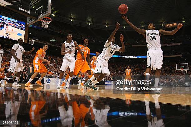 Durell Summers and Korie Lucious both of the Michigan State Spartans pull down a rebound against the Tennessee Volunteers during the midwest regional...